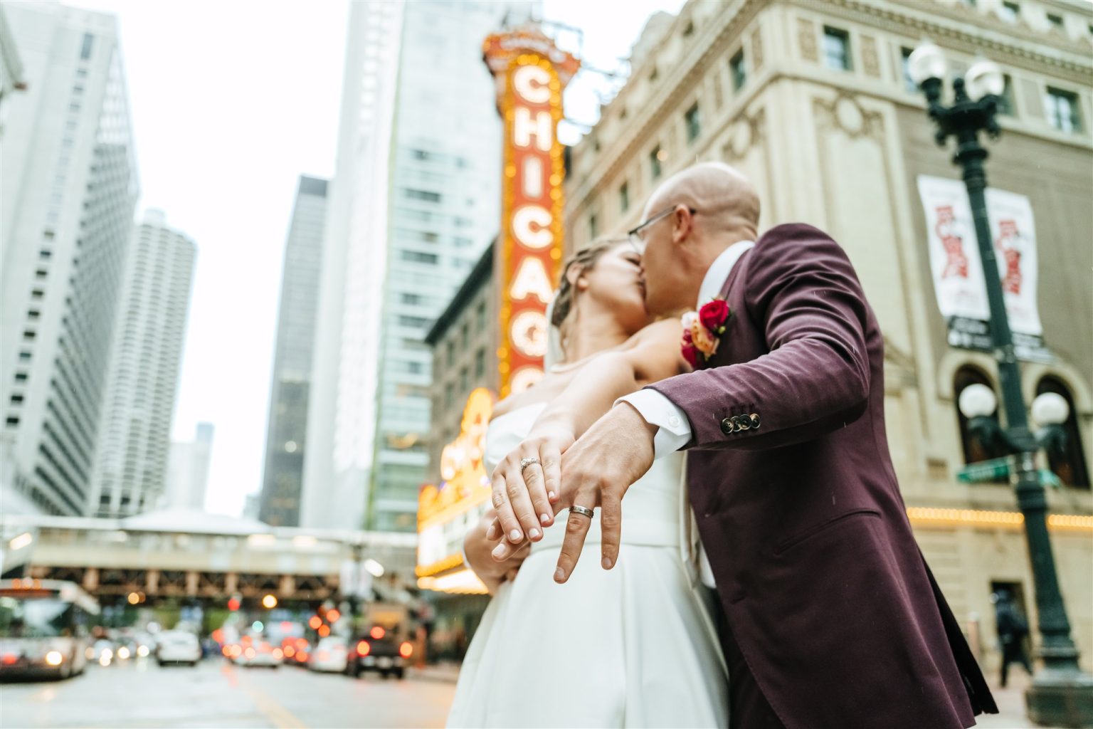 Bride and groom kissing in front of the Chicago Theatre sign — Chicago wedding photographer IG Photo Video
